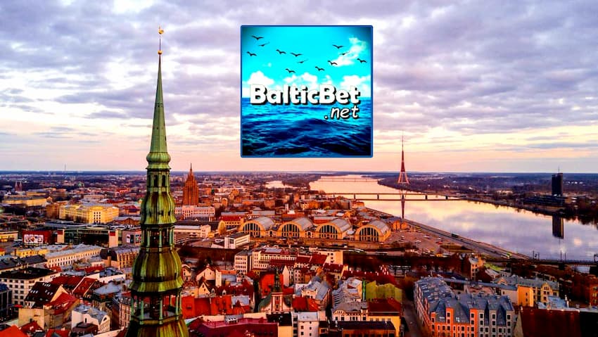 Portal logo BalticBet.net tsjin 'e eftergrûn fan' e stêd Riga, de haadstêd fan Letlân, foar de Oer Us side is op 'e foto.